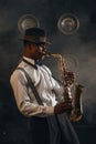 Black jazzman plays the saxophone on stage Royalty Free Stock Photo
