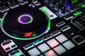 Black Jog wheel of DJ Controller with glowing lights around it showing performance pads MPC style Royalty Free Stock Photo