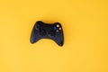 Black joystick is isolated on a yellow background. Video game competition. Gaming concept Royalty Free Stock Photo