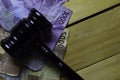 Black Judges gavel and Indonesian Rupiah on Wooden desk. Law concept Royalty Free Stock Photo