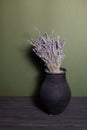 black jug with lavender flowers on a beautiful background Royalty Free Stock Photo