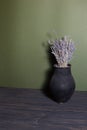 black jug with lavender flowers on a beautiful background Royalty Free Stock Photo