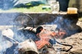 Black kettle tea pot on fire wood outdoor Royalty Free Stock Photo