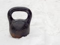 Black kettlebell in snow background