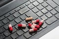 Black Keyboard and antibiotics capsule on infected laptop