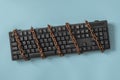 Black keyboard with a coiled chain. Concept for the topic of censorship or freedom of the press