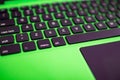 black keyboard on a green laptop. keys with letters and numbers. Detail of a laptop computer. Image detail to describe IT tools, Royalty Free Stock Photo