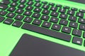 black keyboard on a green laptop. keys with letters and numbers. Detail of a laptop computer. Image detail to describe IT tools, Royalty Free Stock Photo
