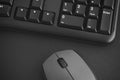 Black keyboard and grey wireless mouse on a desk Royalty Free Stock Photo