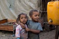 Black kid beside of canister