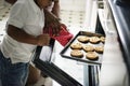 Black kid helping mom baking cookies in the kitchen Royalty Free Stock Photo
