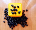 Black kidney beans on the wooden background and yellow cube