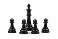 Black king chess piece surrounded by four pawns. People, group gathered around the ruler. Boss, leader, guru, authority, influence