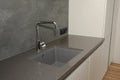 Black kitchen sink and Tap water in the kitchen. Modern kitchen metal faucet and  kitchen sink Royalty Free Stock Photo