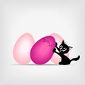 Black kitty with big pink easter eggs Royalty Free Stock Photo