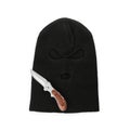 Black knitted balaclava and knife on white background, top view Royalty Free Stock Photo