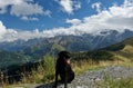 Cute dog in the foreground with amazing panorama of the mount blanc in the background.