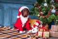 The black labrador retriever sitting with gifts on Christmas decorations background Royalty Free Stock Photo