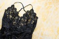 Black lace lingerie with beauty care products, make up cosmetics, jewelry in black and gold. Fashion flat lay, top view Royalty Free Stock Photo