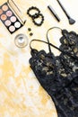 Black lace lingerie with beauty care products, make up cosmetics, jewelry in black and gold. Fashion flat lay, top view Royalty Free Stock Photo