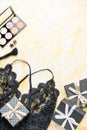 Black lace lingerie with beauty care products, make up cosmetics, jewelry in black and gold. Fashion flat lay, top view Royalty Free Stock Photo