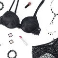 Black lace lingerie, jewelry and beauty products on white background. Royalty Free Stock Photo
