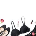 Black lace lingerie, jewelry and beauty products on white background. Royalty Free Stock Photo