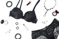 Black lace lingerie, jewelry and beauty products on white background. Royalty Free Stock Photo