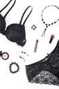 Black lace lingerie, jewelry and beauty products on white background. Royalty Free Stock Photo