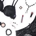 Black lace lingerie, jewelry and beauty products on white background. Royalty Free Stock Photo
