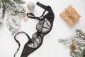 Black lace lingerie and perfume bottle. Top view. Gift set of women`s accessories and underwear