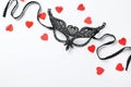Black lace mask for sexual role play and red hearts on background