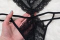 Black lace panties in a female hand. Close-up. Fashion lingerie concept Royalty Free Stock Photo