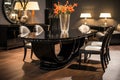 a black lacquered art deco dining table with elegantly curved chairs