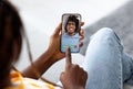 Black lady holding smartphone and making video call with her boyfriend, relaxing on couch at home, collage