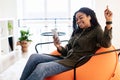 Black lady listening to music in wireless headphones and dancing Royalty Free Stock Photo