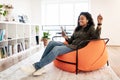 Black lady listening to music in wireless headphones and dancing Royalty Free Stock Photo