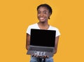 Black Lady Showing Laptop Screen Holding Computer On Yellow Background Royalty Free Stock Photo