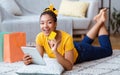 Black lady using tablet and credit card at home Royalty Free Stock Photo