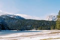 Black lake among a snowy forest at the foot of the mountains. Durmitor National Park, Montenegro Royalty Free Stock Photo