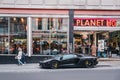 Black Lamborghini parked outside Planet Hollywood restaurant in Haymarket, London, UK