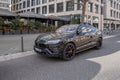 black Lamborghini Urus Car on street of modern European city, Automotive industry and technology, Premium automobiles and status,