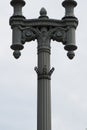 T-shaped ornate black iron lamp post