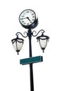 Black lamppost with round clock and green copy space signage