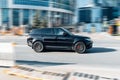 Black Land Rover Range Rover Sport L494 car in fast motion on the city street