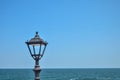 Black lantern on a background of blue sea and sky Royalty Free Stock Photo