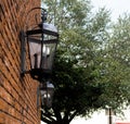 Black lanterns on brick wall in city street Royalty Free Stock Photo