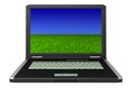 Black laptop with grass and sky on screen Royalty Free Stock Photo
