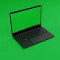 A black laptop is positioned at an angle, displaying a green screen. The keyboard is Royalty Free Stock Photo