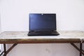 Black laptop on a wooden table 1 Royalty Free Stock Photo